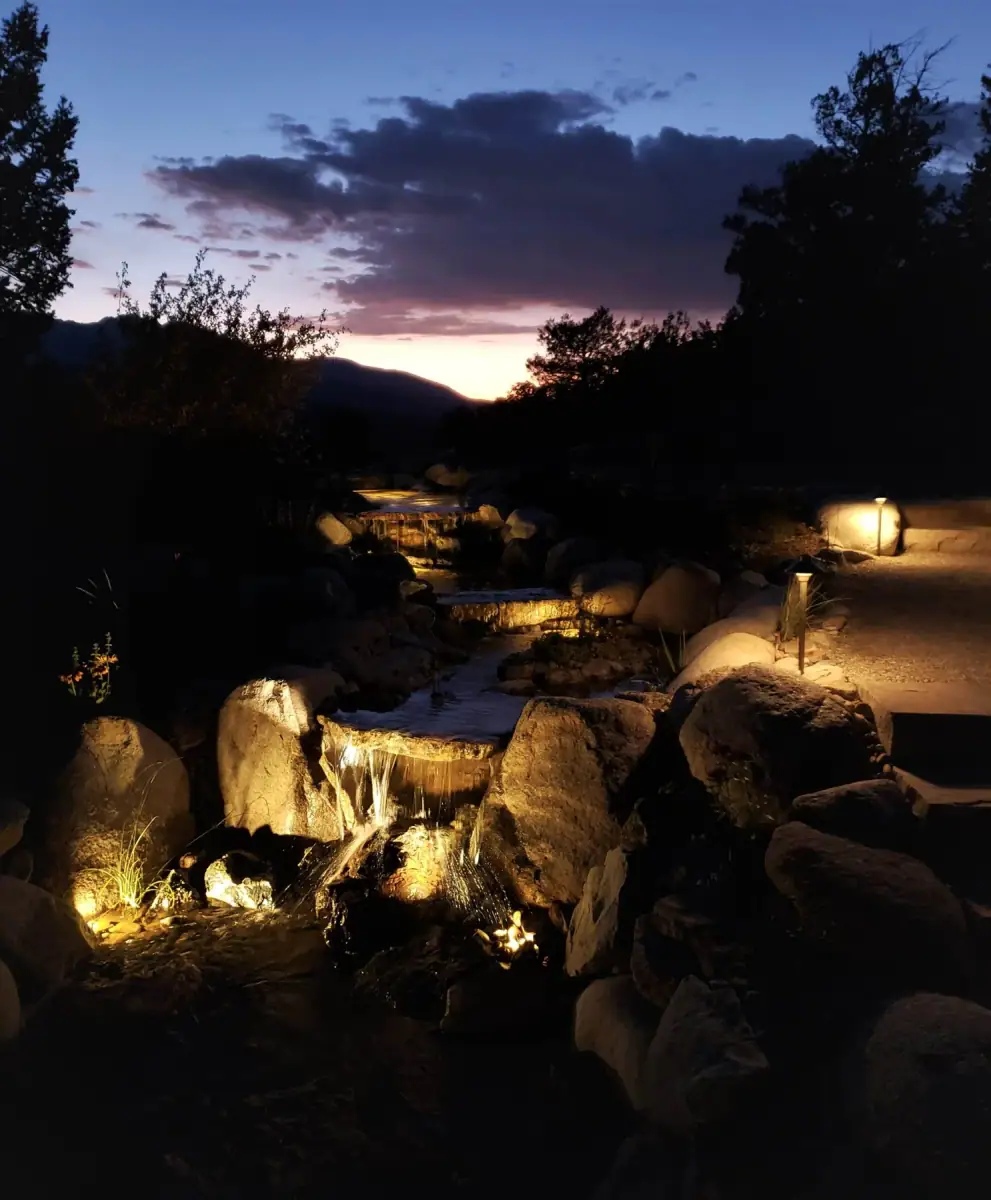 Illuminated water feature in a Neils Lunceford landscape at night